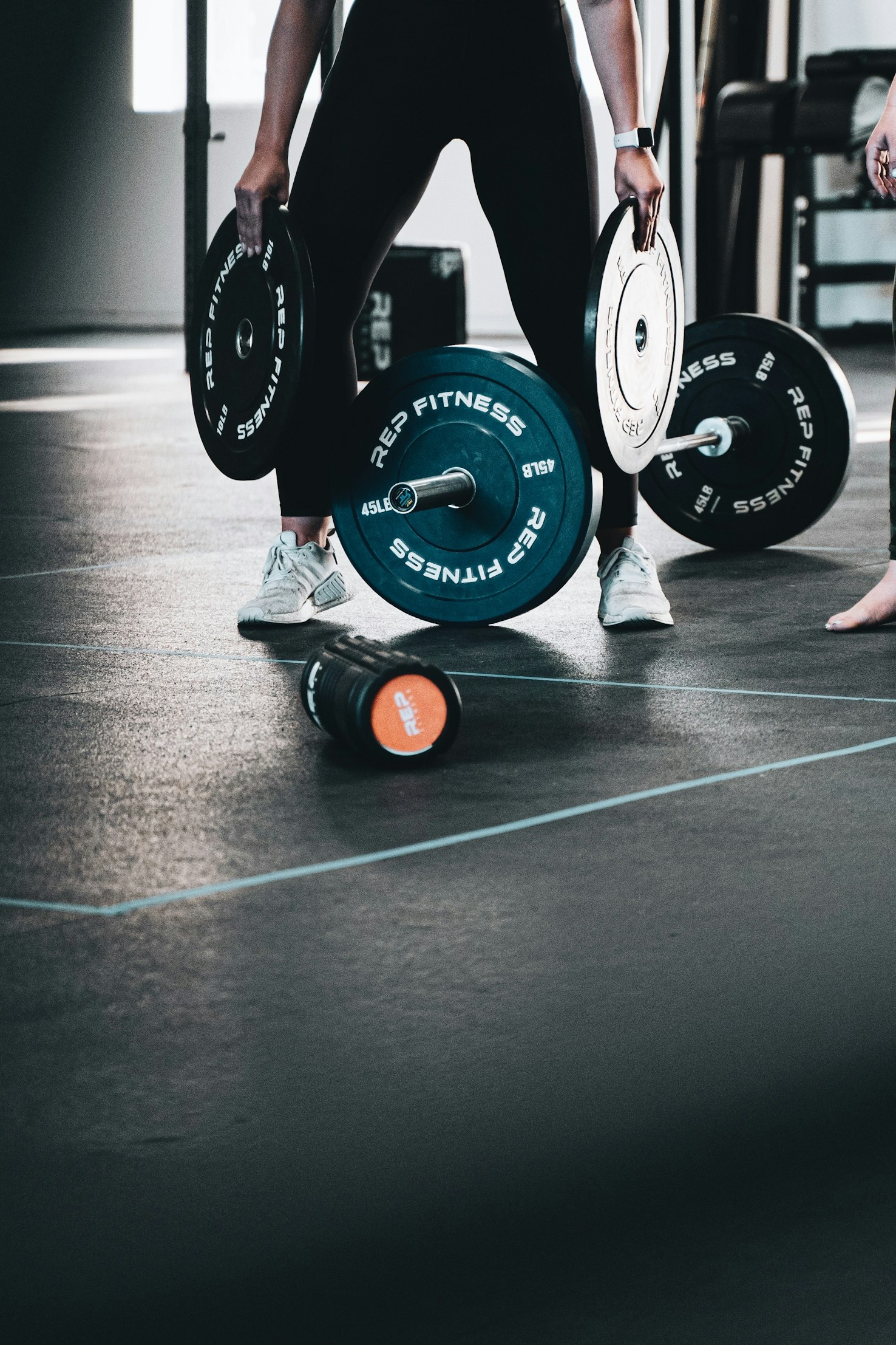 Person setting up a custom workout timer on a smartphone while in a gym setting