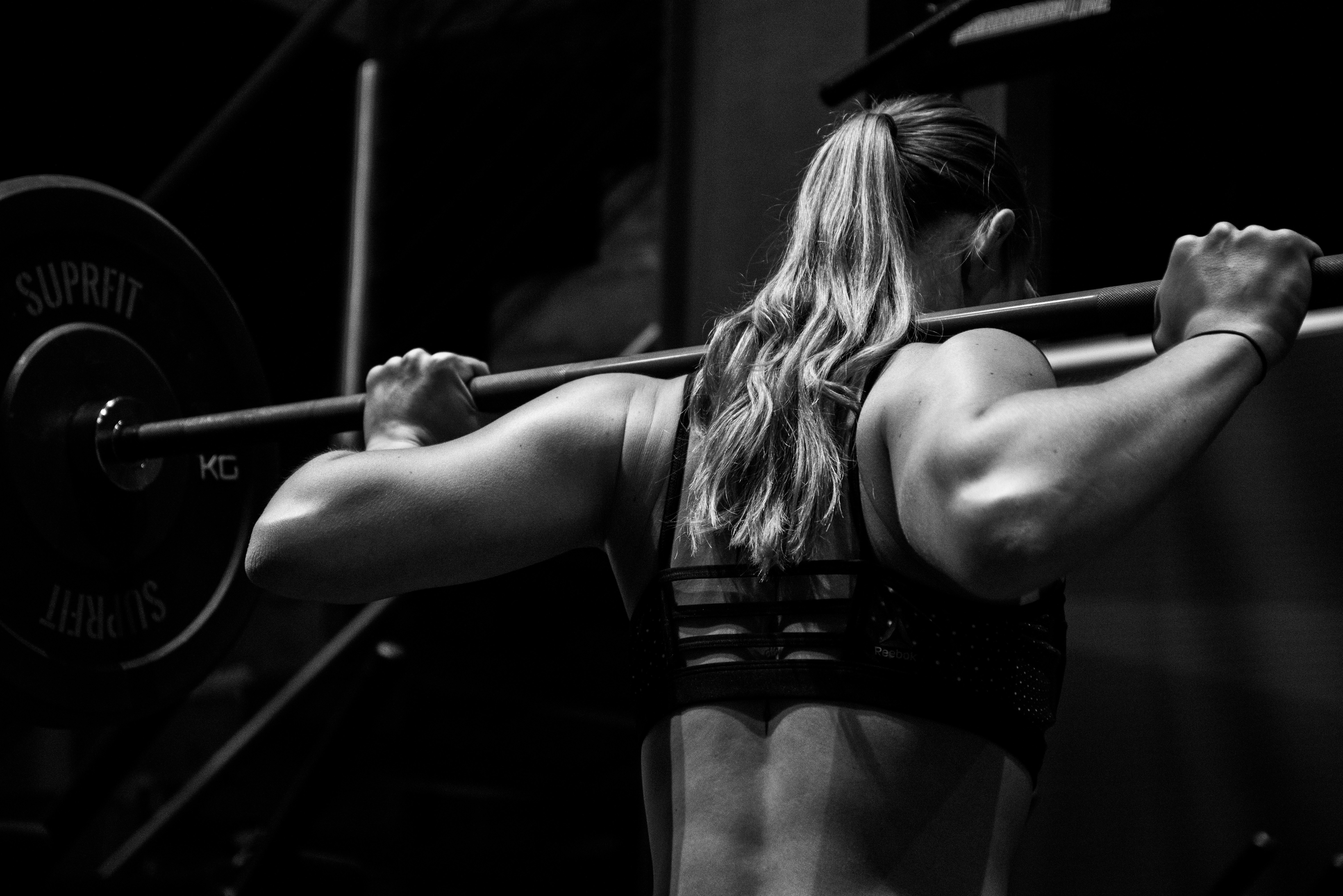 Person customizing a HIIT timer app on smartphone during workout