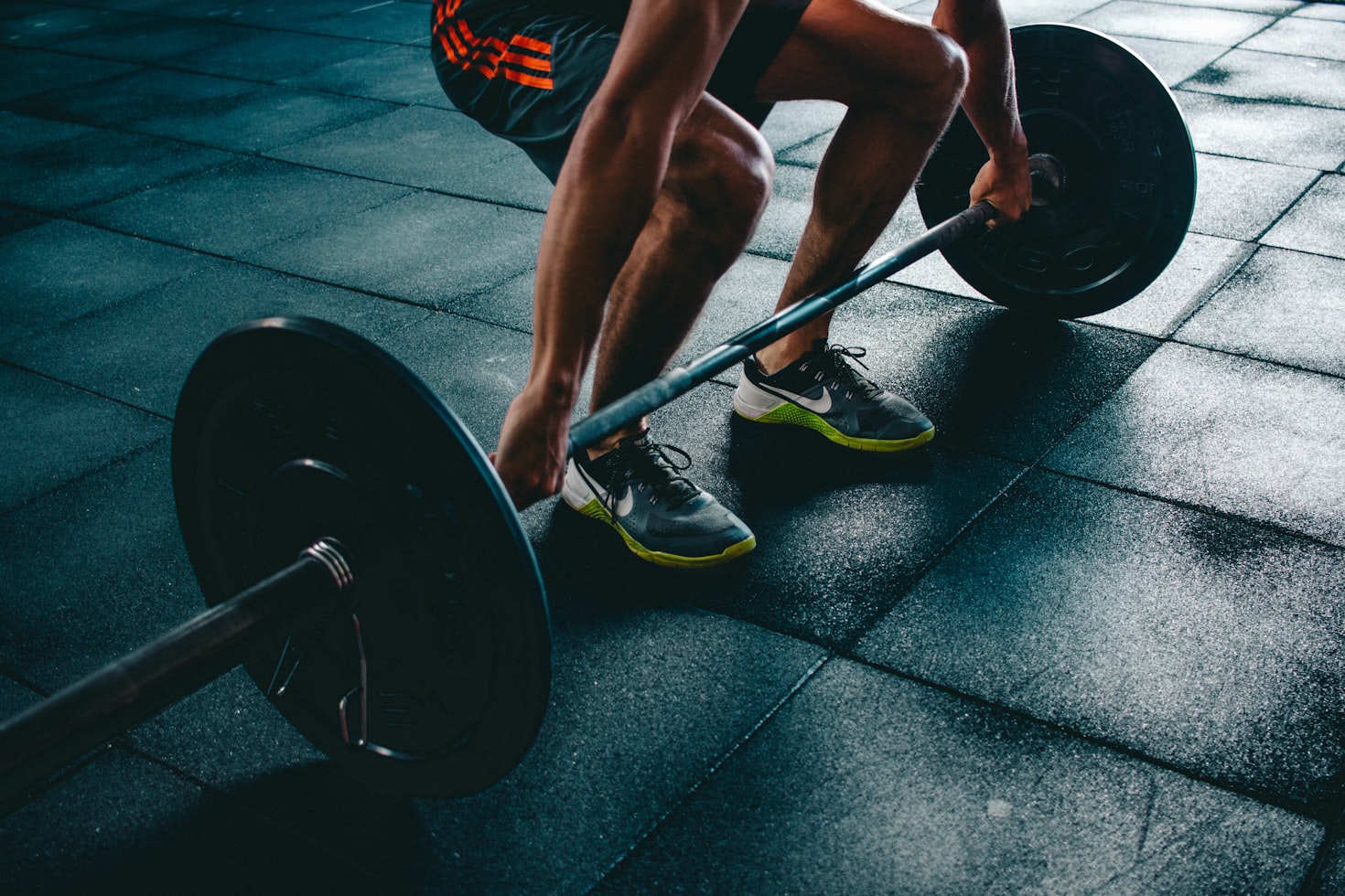 Person drinking water during a break in a high-intensity interval training workout